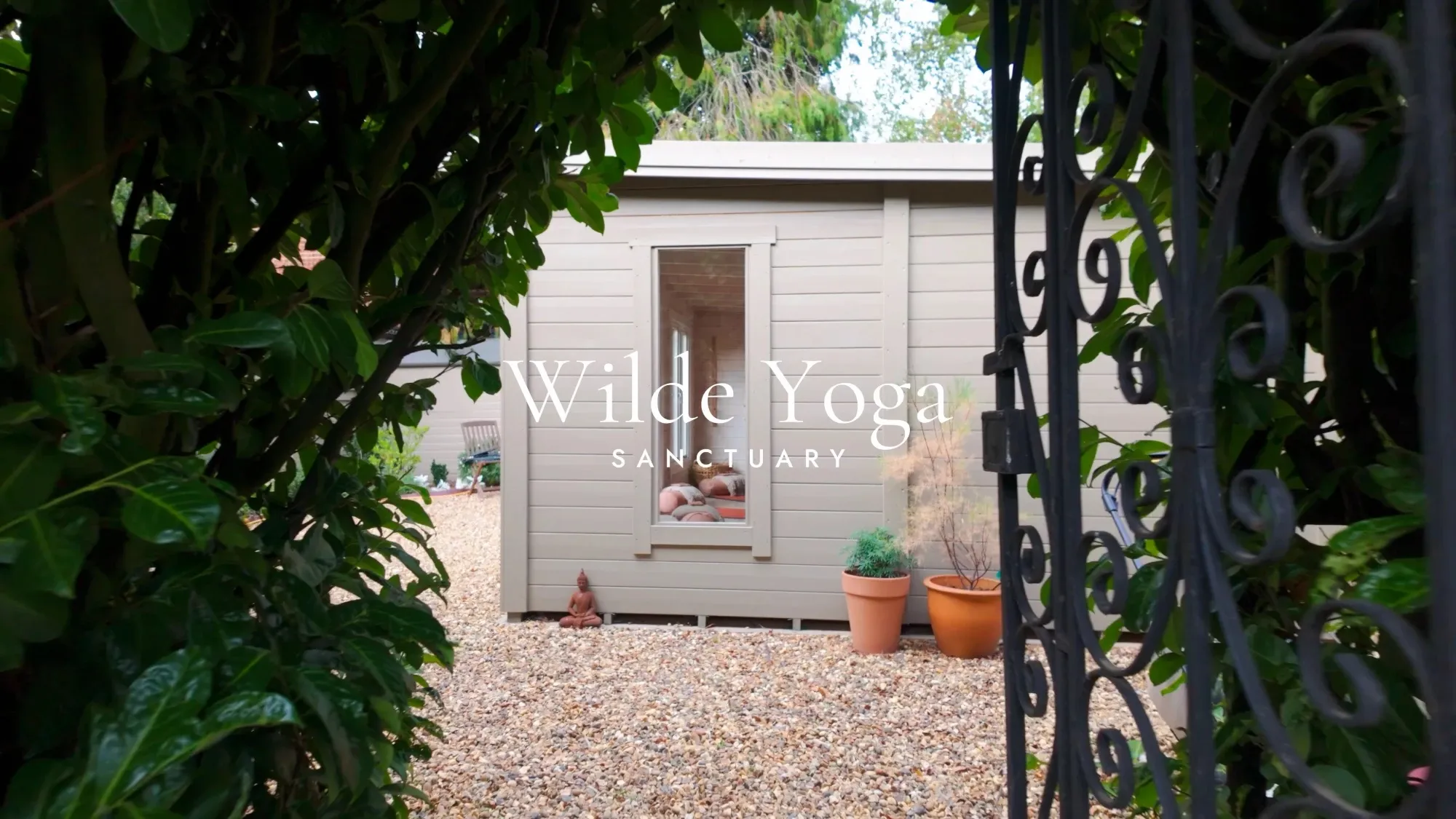 The Wilde Yoga Sanctuary garden studio, seen through the garden gate